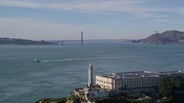 5K aerial stock footage tilt up to reveal and fly over Alcatraz, approach Golden Gate Bridge, San Francisco, California Aerial Stock Footage | AXSF05_069