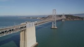 5K aerial stock footage of flying by the Bay Bridge with light traffic, San Francisco, California Aerial Stock Footage | AXSF05_077