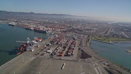 5K aerial stock footage of panning across shipping containers and flying over the Port of Oakland, California Aerial Stock Footage | AXSF05_080