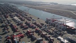 5K aerial stock footage flyby cargo containers to ships docked under cranes, Port of Oakland, Oakland, California Aerial Stock Footage | AXSF05_081