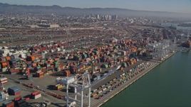 5K aerial stock footage flying by cargo cranes, and stacks of shipping containers, Port of Oakland, Oakland, California Aerial Stock Footage | AXSF05_082
