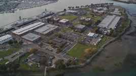5K aerial stock footage tilt from bridge to reveal the Coast Guard Island base, Oakland, California Aerial Stock Footage | AXSF06_004