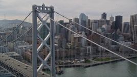 5K aerial stock footage track light traffic then fly over the Bay Bridge toward skyscrapers in Downtown San Francisco, California Aerial Stock Footage | AXSF06_014