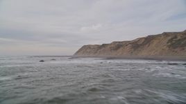 5K aerial stock footage of flying low over waves near coastal cliffs, Bolinas, California Aerial Stock Footage | AXSF06_059
