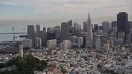 5K aerial stock footage approach famous Coit Tower, with Golden Gate Bridge in the distance, and orbit to reveal Downtown San Francisco, California Aerial Stock Footage | AXSF06_082