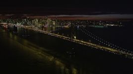 5K aerial stock footage of approaching Bay Bridge with city skyline in distance, San Francisco, California, night Aerial Stock Footage | AXSF07_003