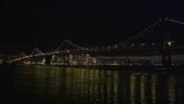 5K aerial stock footage low altitude approach to the Bay Bridge and downtown skyline, San Francisco, California, night Aerial Stock Footage | AXSF07_004