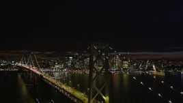 5K aerial stock footage ascend and fly over Bay Bridge, approach Downtown San Francisco skyline, California, night Aerial Stock Footage | AXSF07_005