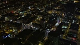 5K aerial stock footage tilt from city buildings to reveal and approach skyscrapers in Downtown San Francisco, California, night Aerial Stock Footage | AXSF07_011
