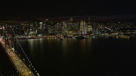 5K aerial stock footage fly away from the Downtown San Francisco skyline, revealing Bay Bridge, California, night Aerial Stock Footage | AXSF07_014