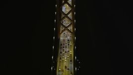 5K aerial stock footage tilt from bird's eye of Bay Bridge, reveal cargo ship, San Francisco, California, night Aerial Stock Footage | AXSF07_029