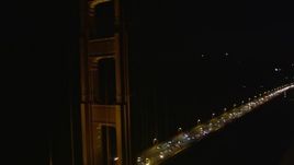 5K aerial stock footage tilt up from traffic and fly by Golden Gate Bridge, San Francisco, California, night Aerial Stock Footage | AXSF07_039