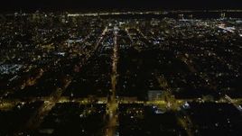 5K aerial stock footage of following Fulton Street, tilt to reveal city hall, Western Addition, San Francisco, California, night Aerial Stock Footage | AXSF07_054