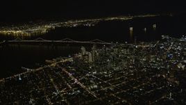 5K aerial stock footage of a high altitude view of Bay Bridge and skyscrapers in Downtown San Francisco, California, night Aerial Stock Footage | AXSF07_072