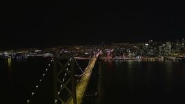 5K aerial stock footage reverse view of the Bay Bridge and Downtown San Francisco, California, night Aerial Stock Footage | AXSF07_084