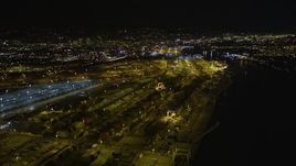 5K aerial stock footage video of flying over rows of containers at the Port of Oakland, California, night Aerial Stock Footage | AXSF07_087
