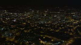5K aerial stock footage tilt from light traffic on Interstate 880, reveal and fly over Downtown Oakland, California, night Aerial Stock Footage | AXSF07_090