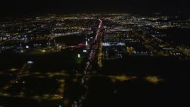 5K aerial stock footage follow I-880 toward O.co Coliseum and Oracle Arena, tilt down, Oakland, California, night Aerial Stock Footage | AXSF07_098