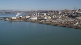 5K aerial stock footage of flying by ConocoPhillips Oil Refinery, seen from San Pablo Bay, Rodeo, California Aerial Stock Footage | AXSF08_016