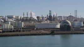 5K aerial stock footage flying by ConocoPhillips Oil Refinery by San Pablo Bay, Rodeo, California Aerial Stock Footage | AXSF08_017