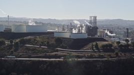 5K aerial stock footage of ConocoPhillips Oil Refinery, light traffic passing by, Rodeo, California Aerial Stock Footage | AXSF08_019
