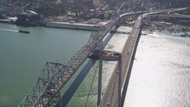 5K aerial stock footage of tilting from a docked ship at California Maritime Academy to reveal and fly over Carquinez Bridge, California Aerial Stock Footage | AXSF08_026