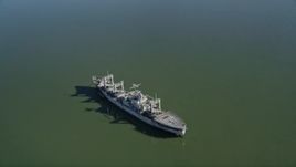 5K aerial stock footage tilt from Suisun Bay, reveal National Defense Reserve Fleet warship, Suisun Bay, California Aerial Stock Footage | AXSF08_037