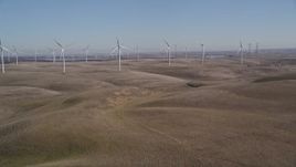 5K aerial stock footage of tilting from brown hills revealing Shiloh Wind Power Plant, Montezuma Hills, California Aerial Stock Footage | AXSF08_066