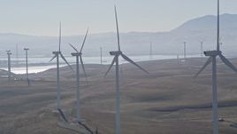 5K aerial stock footage of flying by a row of windmills, Shiloh Wind Power Plant, Montezuma Hills, California Aerial Stock Footage | AXSF08_075