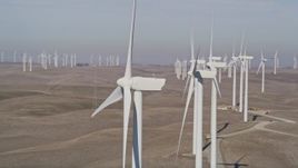 5K aerial stock footage orbit and pass by tops of windmills at Shiloh Wind Power Plant, Montezuma Hills, California Aerial Stock Footage | AXSF08_076