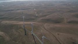 5K aerial stock footage of flying by a row of windmills, Shiloh Wind Power Plant, Montezuma Hills, California Aerial Stock Footage | AXSF08_079