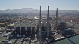5K aerial stock footage tilt from piers to reveal a power plant with smoke stacks in Pittsburg, California Aerial Stock Footage | AXSF08_084