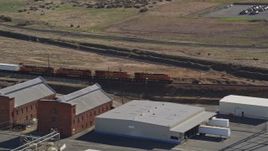 5K aerial stock footage track a train passing by industrial buildings, Bay Point, California Aerial Stock Footage | AXSF08_093