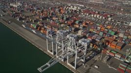 5K aerial stock footage of flying by shipping containers, cargo cranes at Port of Oakland, California Aerial Stock Footage | AXSF09_022