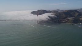 5K aerial stock footage of of the Marin Hills and famous Golden Gate Bridge, shrouded in fog, San Francisco, California Aerial Stock Footage | AXSF09_024