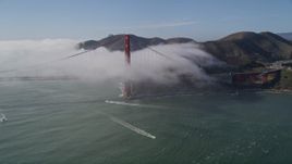 5K aerial stock footage tilt to reveal the fog shrouded Golden Gate Bridge, San Francisco, California Aerial Stock Footage | AXSF09_025