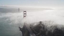 5K aerial stock footage of thick fog rolling over Golden Gate Bridge, San Francisco, California Aerial Stock Footage | AXSF09_031
