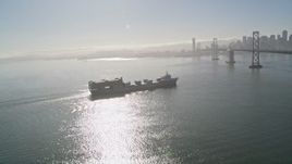 5K aerial stock footage of flying by a cargo ship approaching Bay Bridge, San Francisco, California Aerial Stock Footage | AXSF09_059