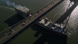 5K aerial stock footage of tracking a cargo ship sailing under Bay Bridge, San Francisco, California Aerial Stock Footage | AXSF09_060