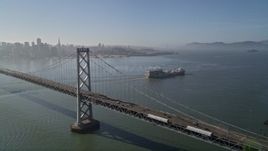 5K aerial stock footage of cargo ship, Bay Bridge, reveal Downtown San Francisco skyline, California Aerial Stock Footage | AXSF09_062