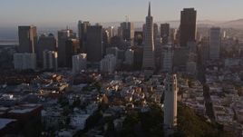 5K aerial stock footage flying by Coit Tower and the Financial District skyline, Downtown San Francisco, California, sunset Aerial Stock Footage | AXSF10_006