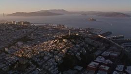 5K aerial stock footage of flying by Coit Tower in North Beach with a view of San Francisco Bay, California, sunset Aerial Stock Footage | AXSF10_025