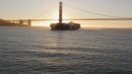 5K aerial stock footage of a cargo ship near Golden Gate Bridge, San Francisco, California, sunset Aerial Stock Footage | AXSF10_031