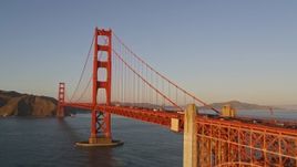 5K aerial stock footage low approach and ascend over the Golden Gate Bridge, San Francisco, California, sunset Aerial Stock Footage | AXSF10_038