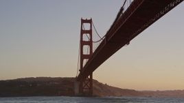 5K aerial stock footage of flying low over the Bay and under the Golden Gate Bridge, San Francisco, California, sunset Aerial Stock Footage | AXSF10_048