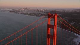 5K aerial stock footage of flying by Golden Gate Bridge tower with Downtown San Francisco skyline in distance, California, sunset Aerial Stock Footage | AXSF10_052