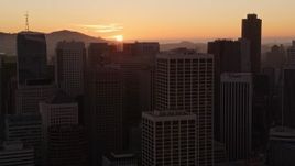 5K aerial stock footage flying past skyscrapers, setting sun in background, Downtown San Francisco, California, sunset Aerial Stock Footage | AXSF10_064
