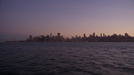 5K aerial stock footage of flying low over the bay with a view of Downtown San Francisco skyline, California, twilight Aerial Stock Footage | AXSF10_088