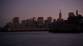 5K aerial stock footage of flying low over the bay by Coit Tower and Downtown San Francisco skyline, California, twilight Aerial Stock Footage | AXSF10_091
