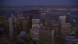5K aerial stock footage tilt from city streets to reveal skyscrapers in Downtown San Francisco and Bay Bridge, California, night Aerial Stock Footage | AXSF10_098